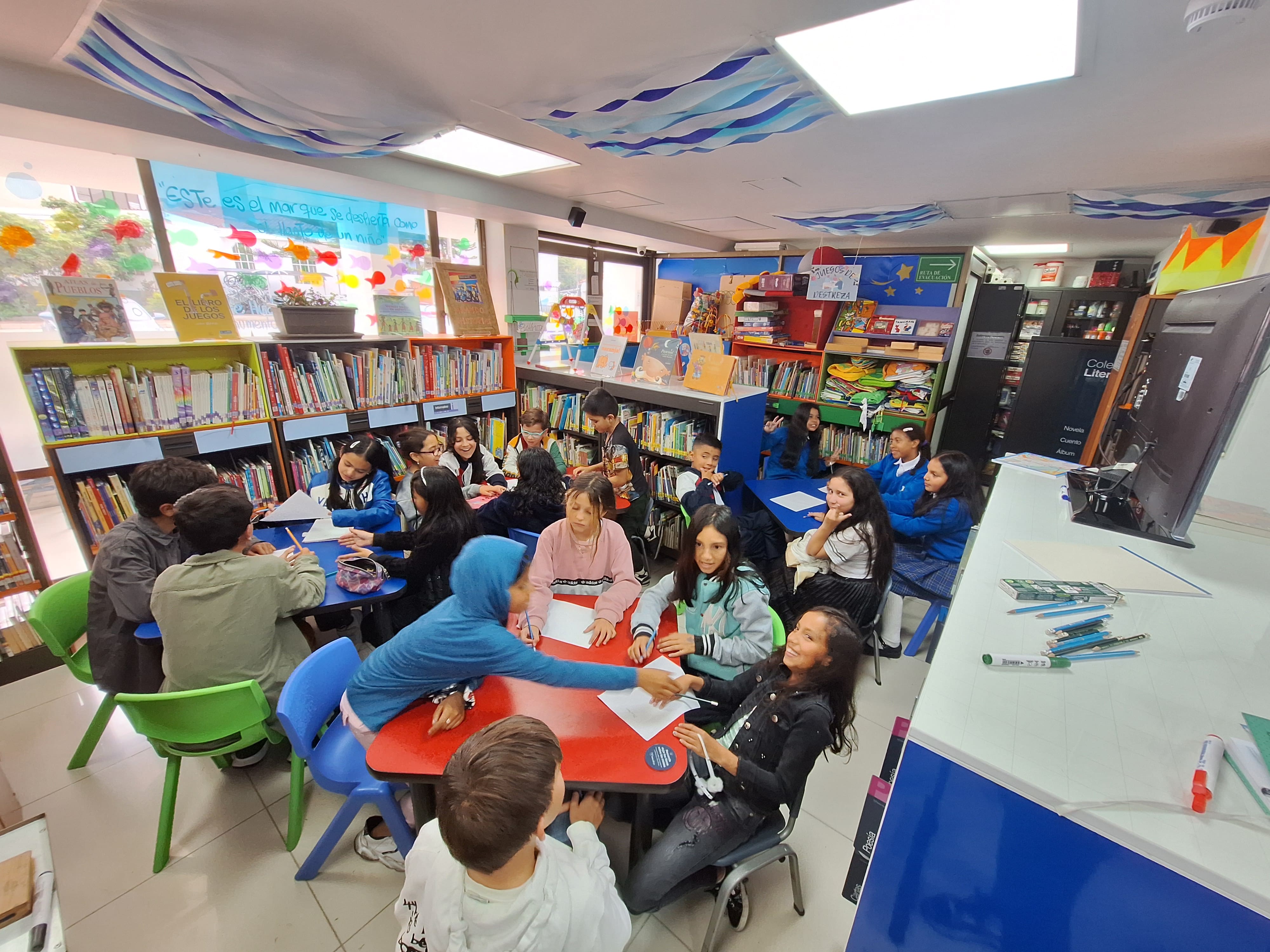 Niñas y niños participando de actividades en la biblioteca