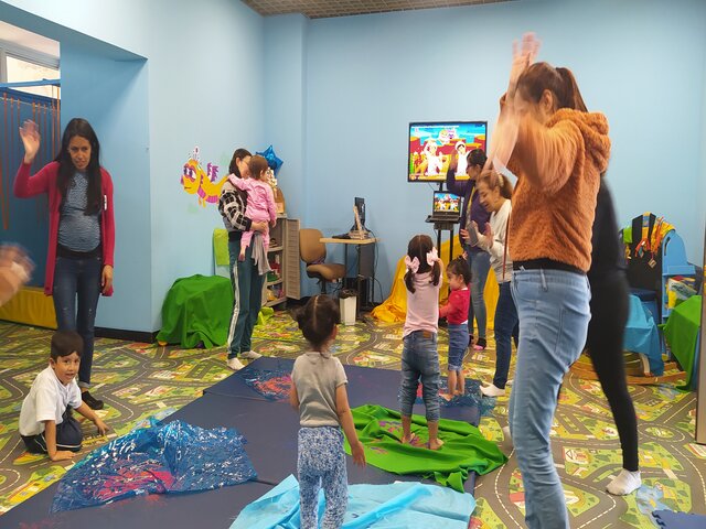 Infancias junto a sus familias participando de actividades lúdicas en la biblioteca