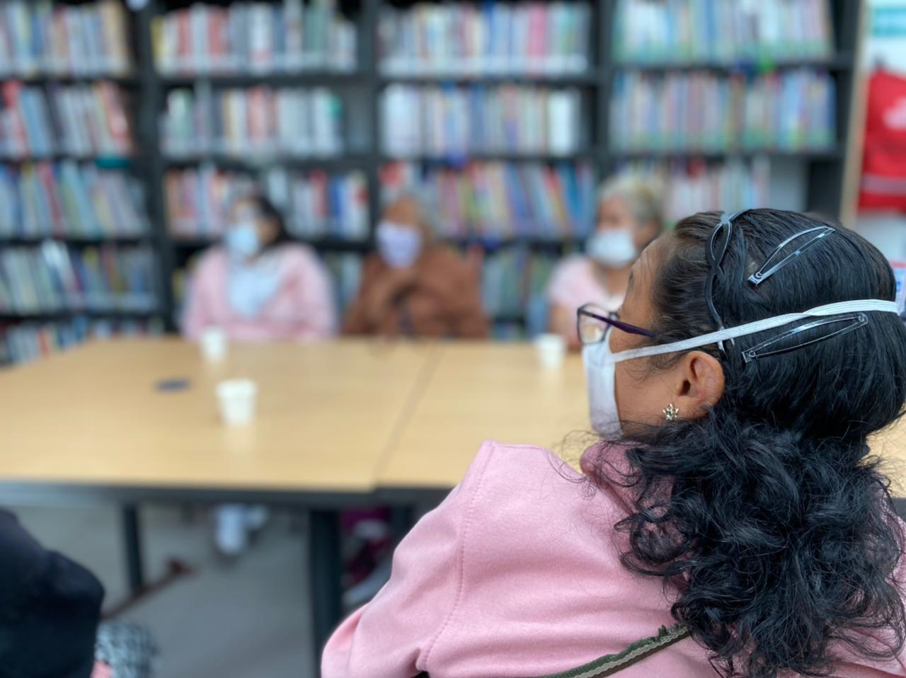 mujer en medio de un salón de biblioteca