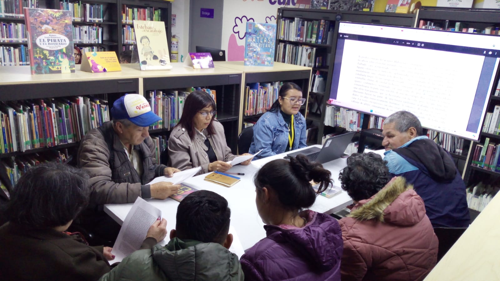 Personas participando en el club de lectura de la biblioteca