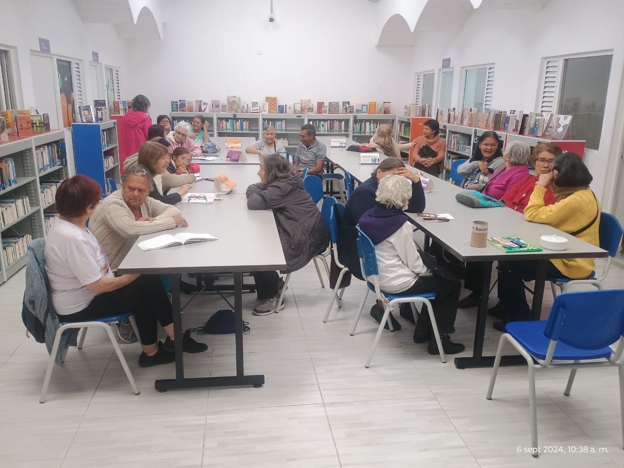 Personas mayores participando en el club de lectura en la biblioteca