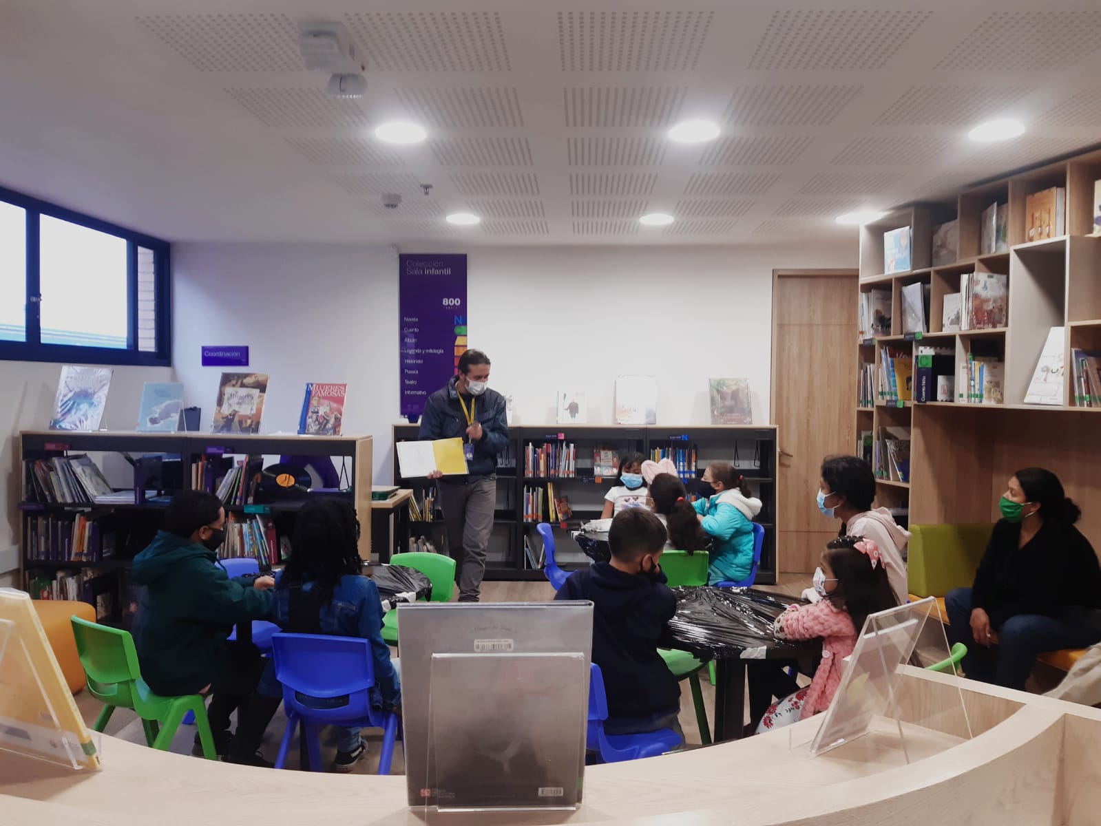 Infancias participando en el club de lectura en la biblioteca