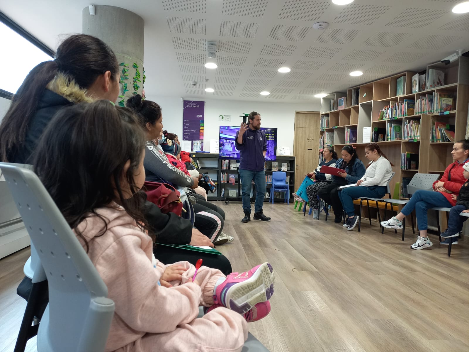 Cuidadores junto a sus bebés participando en actividades sensoriales y lúdicas en la biblioteca